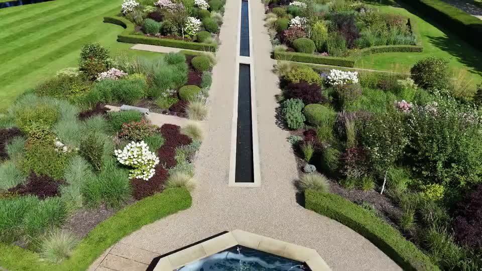 Stock aerial view of planted garden beds and a lawn